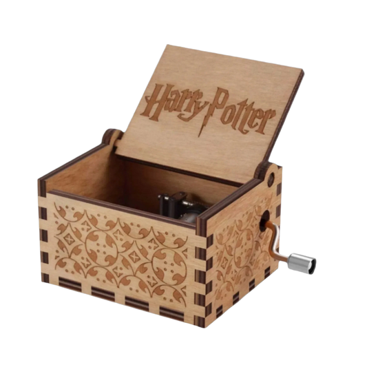 Wooden music box engraved with Hogwarts symbols, plays Hedwig’s Theme from Harry Potter.