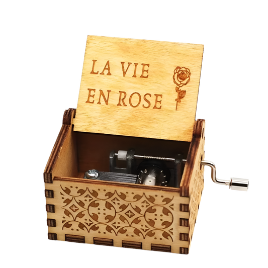 Elegant wooden music box engraved with floral accents, plays "La Vie En Rose" by Édith Piaf.
